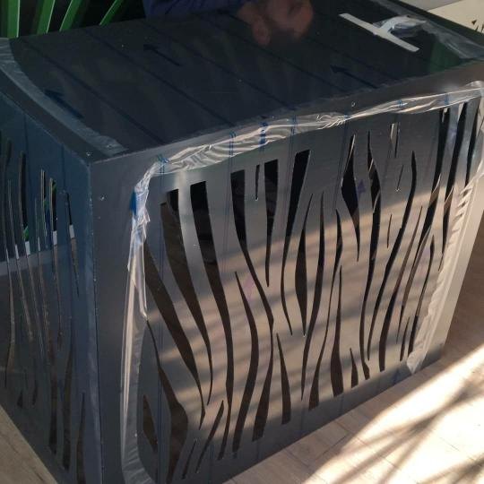 Cache-climatisation anthracite à motif zèbre sous film de protection, en fin de fabrication à l'atelier avant livraison à Prades